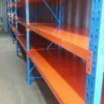 orange and blue shelving units in warehouse