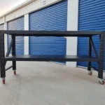 black metal workbench on red wheels