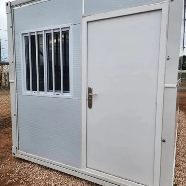 white porta cabin with door and barred window